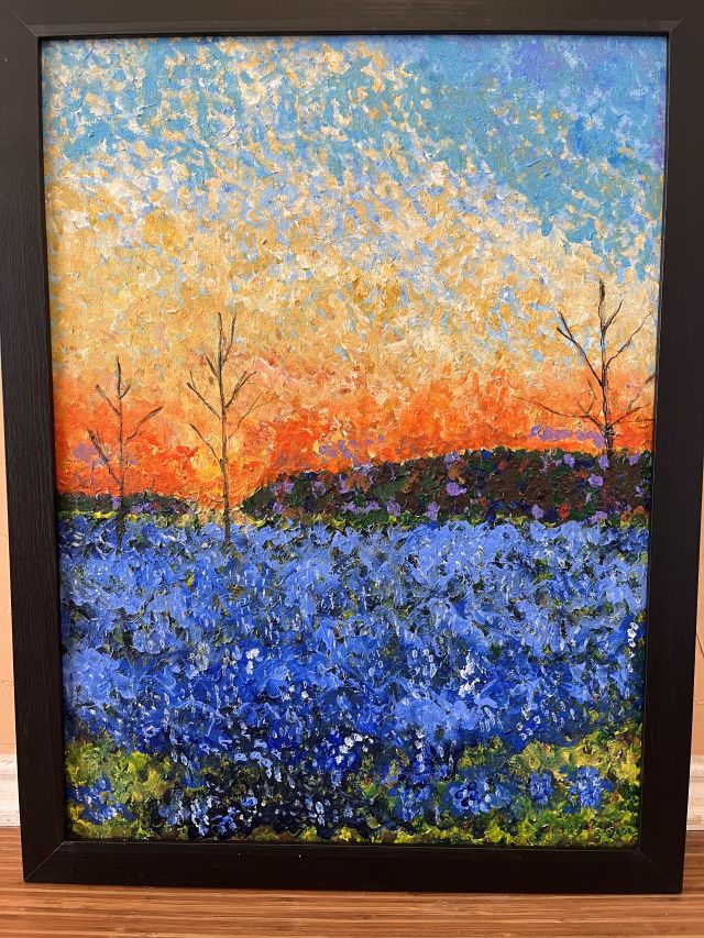 A field of bluebonnets at sunrise
